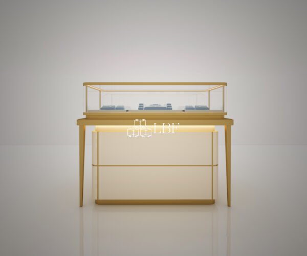 The showcase features a light-luxury design with gold trim frames, paired with high-transmittance tempered glass and built-in warm LED lights to fully reveal the texture of fine jewelry. The enclosed lower storage cabinet offers great practicality. Real-shot photos display its floor-standing layout against shop walls to highlight premium boutique display effects.